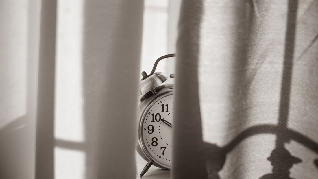 Alarm Clock behind curtains for blog post How to Reset Your Spiritual Life and Reconnect With God  - 